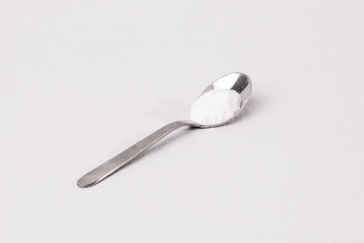 Baking ingredients and measuring spoons for converting baking soda to baking powder
