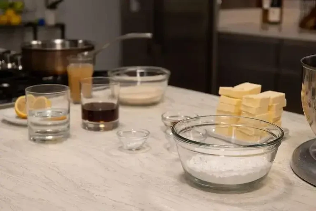 Baking soda and baking powder with measuring spoons on a kitchen counter