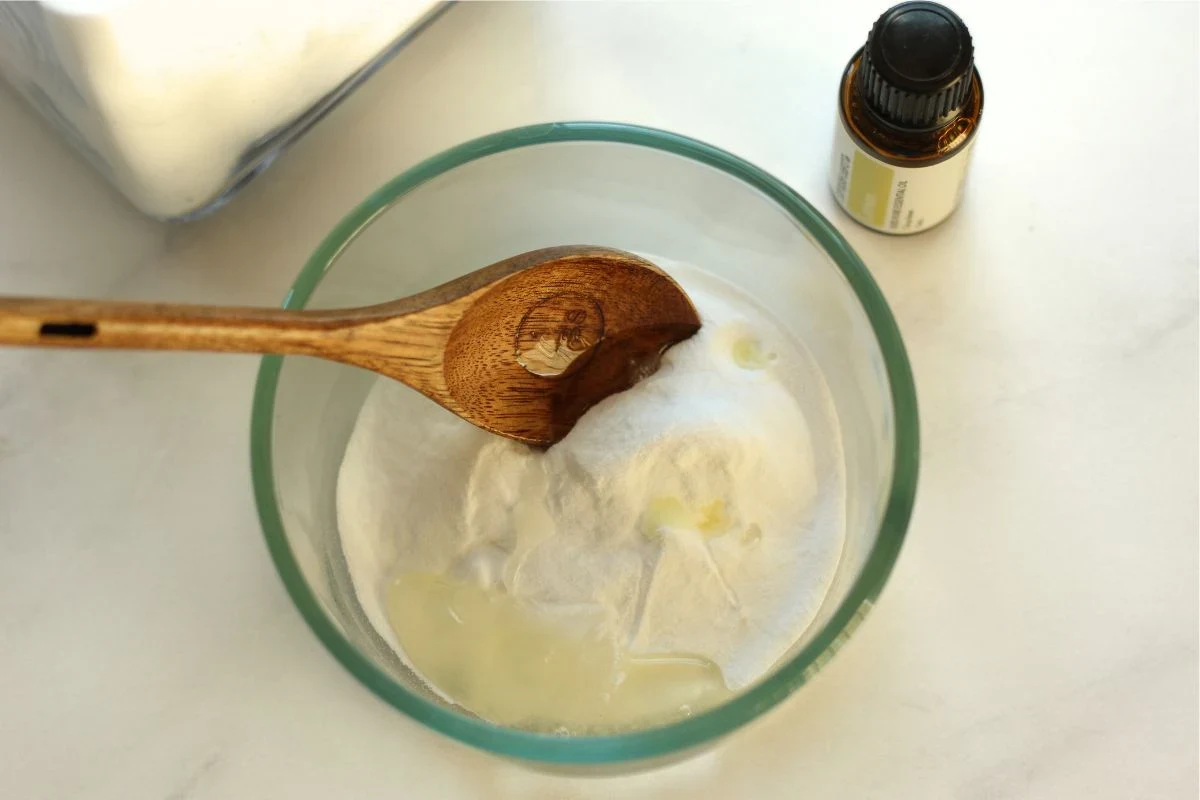 Baking soda bathroom cleaner supplies beside a sink and tub