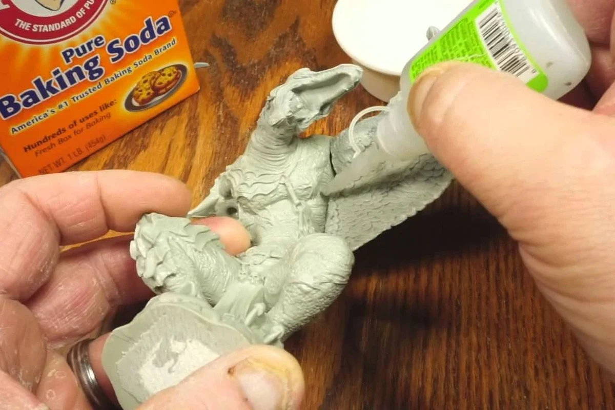Baking soda and crazy glue used for a fast plastic repair on a workbench
