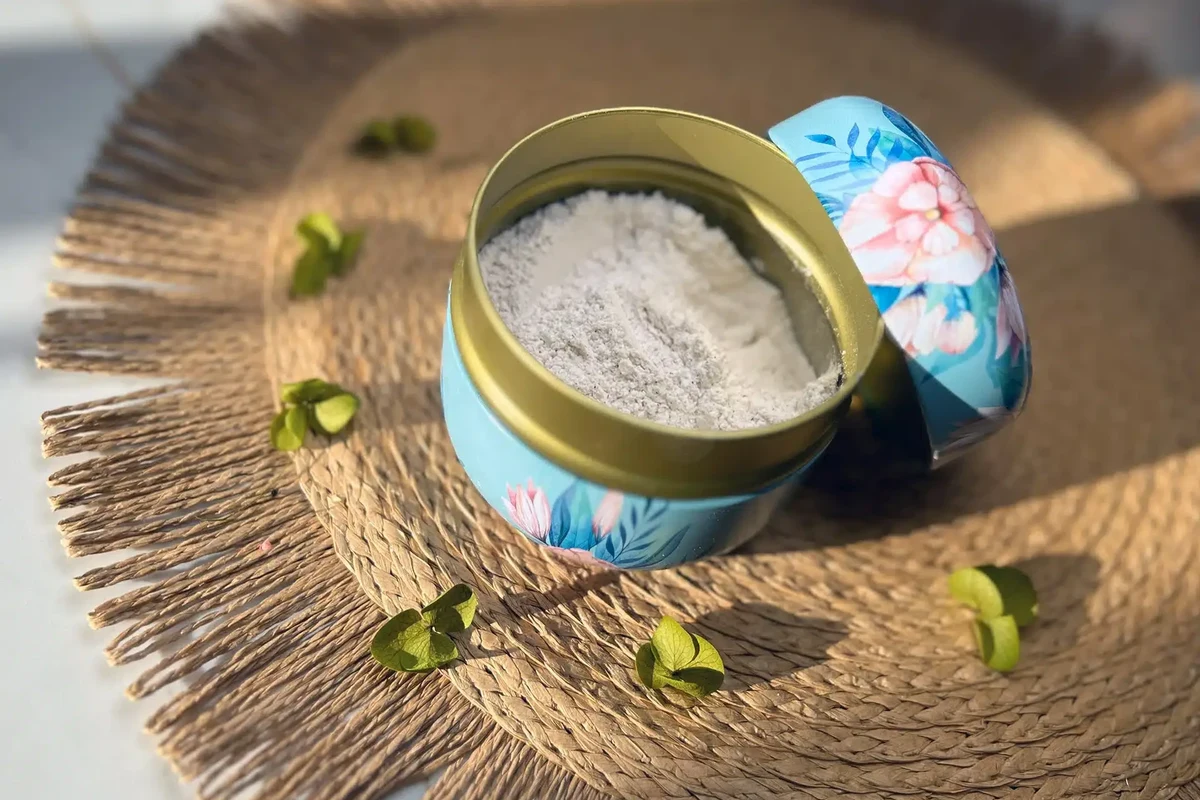 Woman applying baking soda dry shampoo to oily roots for natural hair freshness