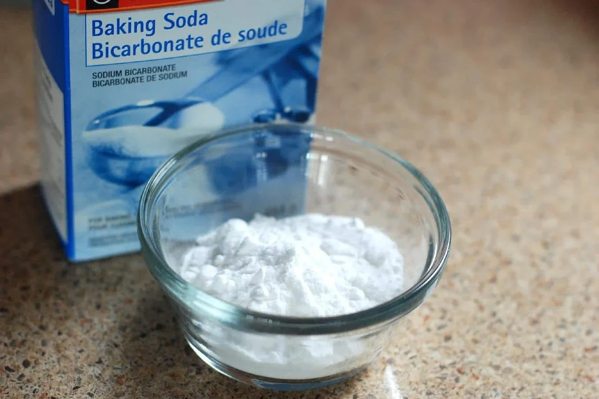 Baking soda in a kitchen near a stove and fire safety tools