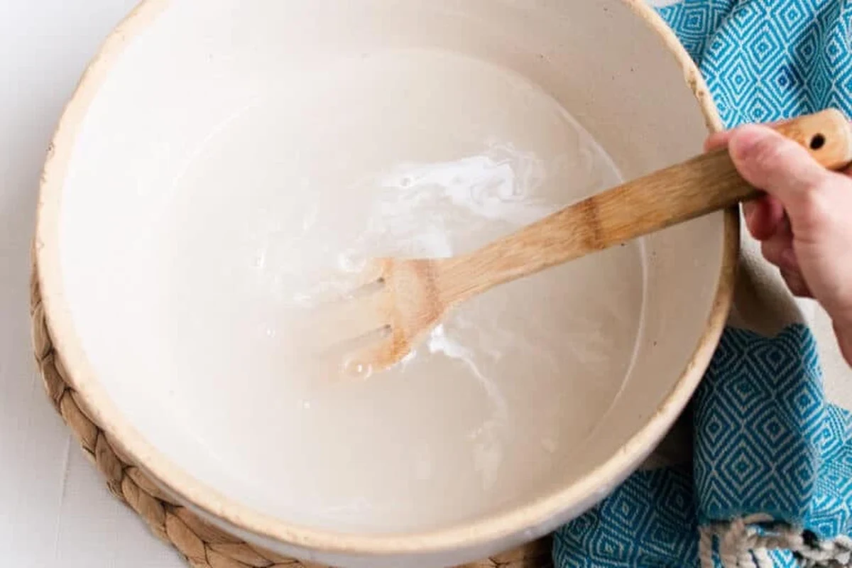 Person soaking feet in a warm baking soda foot soak at home