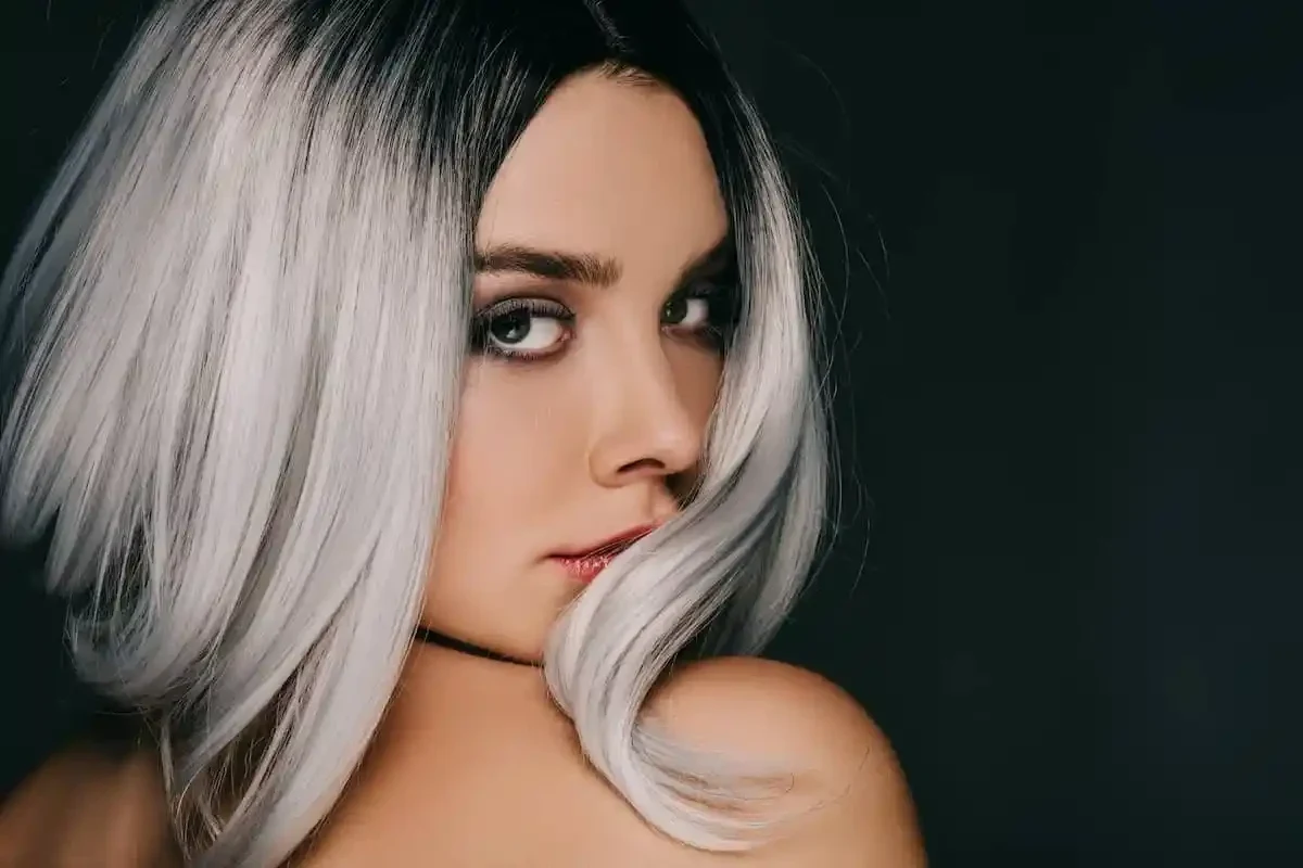 Woman applying baking soda shampoo mixture to faded hair color at home