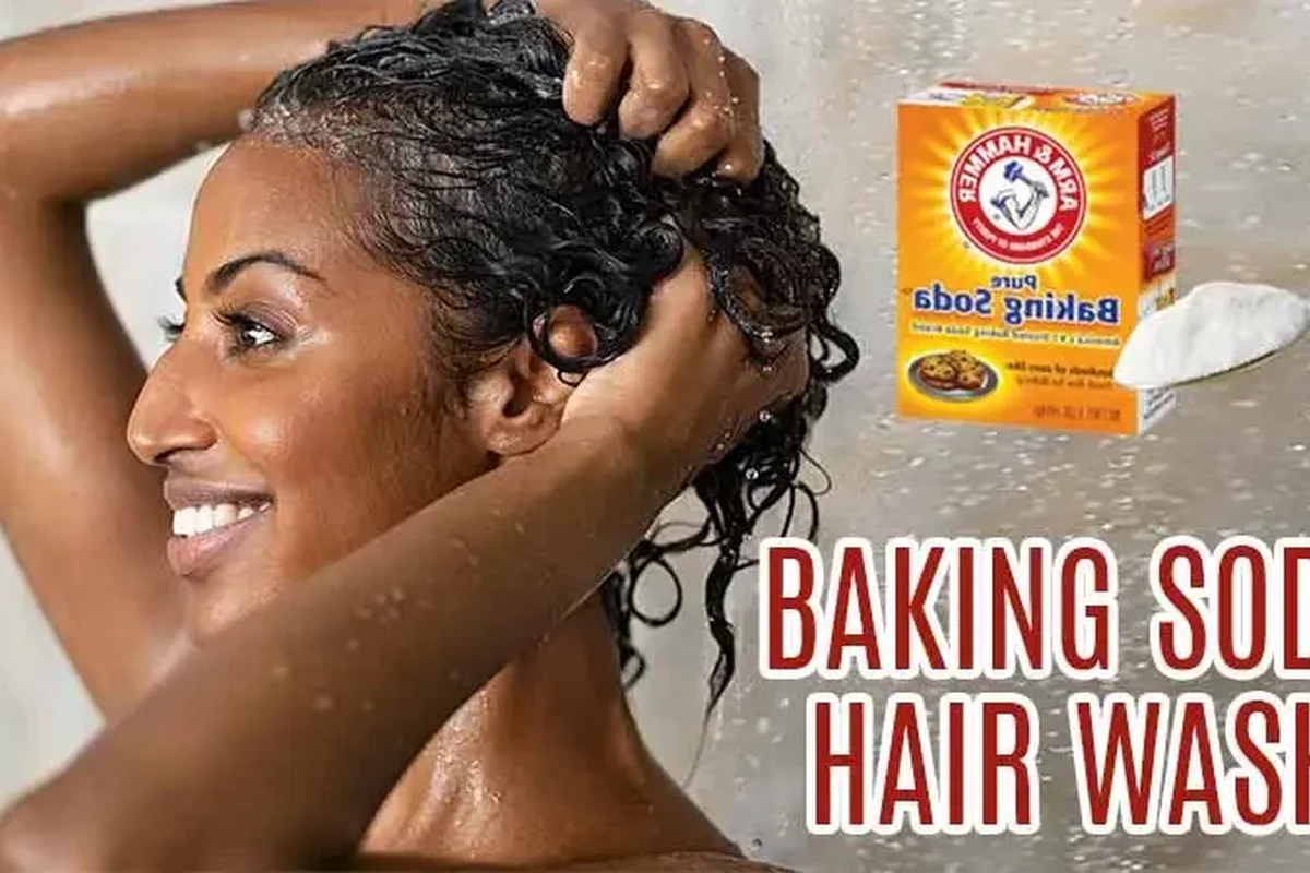 Baking soda hair rinse ingredients and hair care tools on a bathroom counter