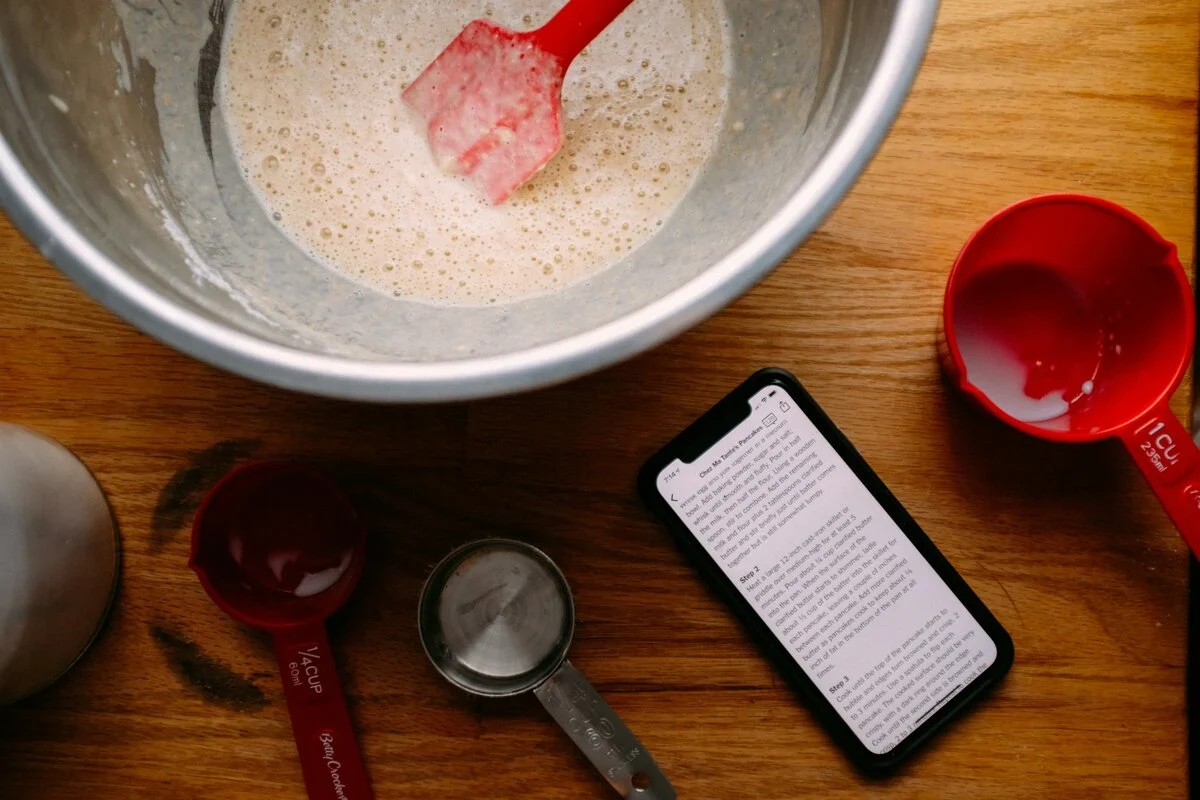 Person holding a glass of water next to baking soda with urinary discomfort concept