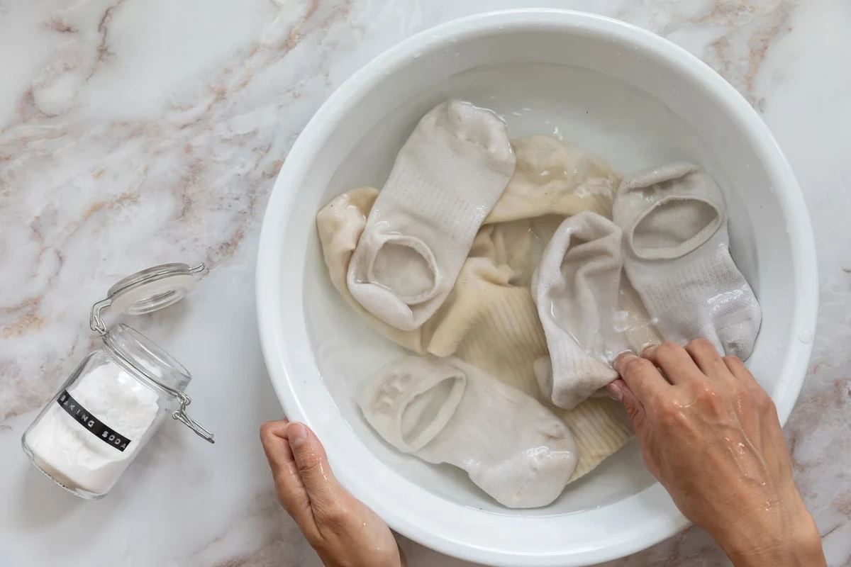 White T-shirts and towels beside baking soda for laundry whitening