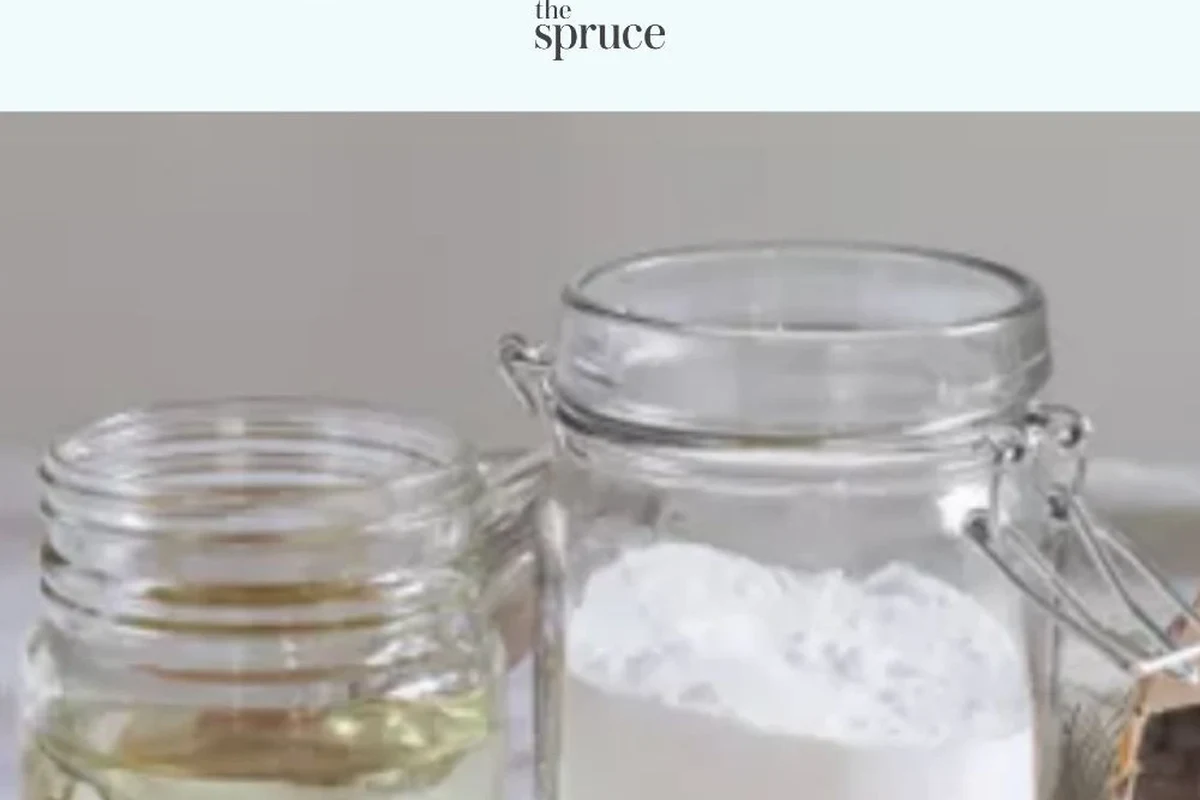 White laundry items with baking soda in a bowl beside detergent and a washing machine