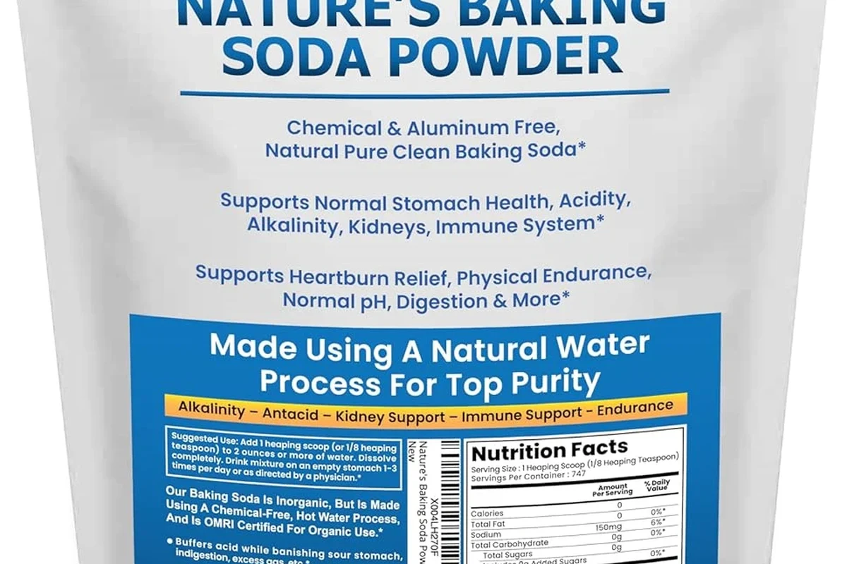 Baking soda without aluminum in a kitchen bowl with measuring spoon and cleaning cloth