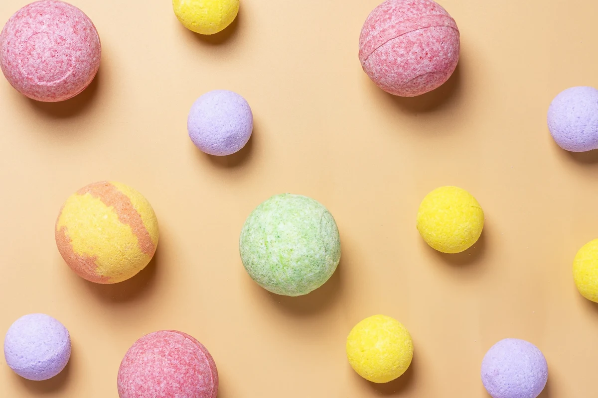 Bath bombs with baking soda fizzing in a warm relaxing bathtub