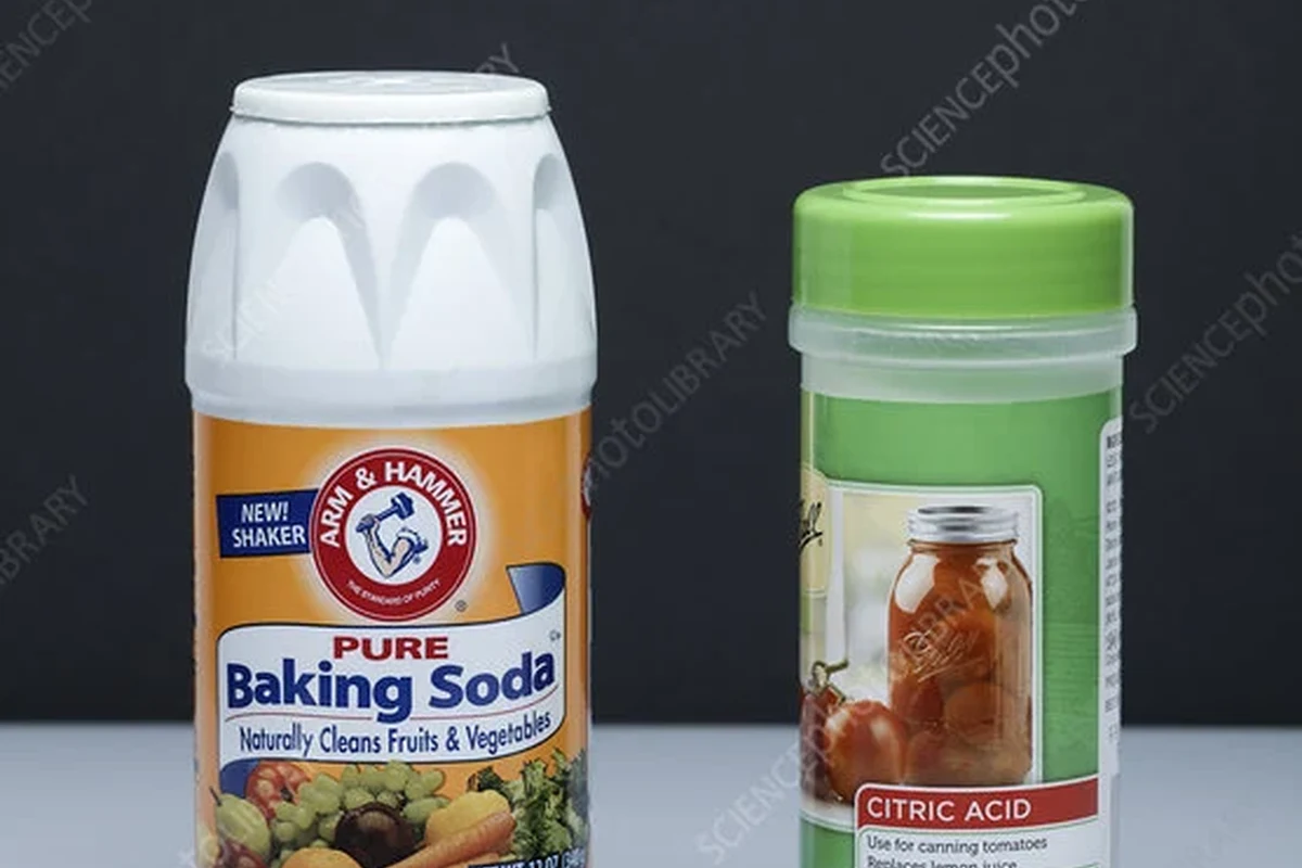 Citric acid and baking soda ingredients for baking in small bowls on a kitchen counter