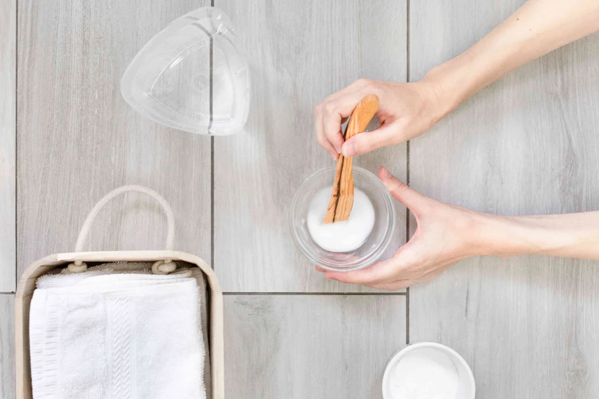 Baking soda paste being applied to a coffee stain on a kitchen towel