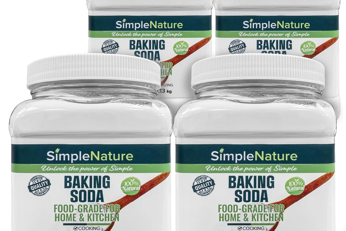 Food grade baking soda in a baking kitchen with measuring spoons and pastry ingredients