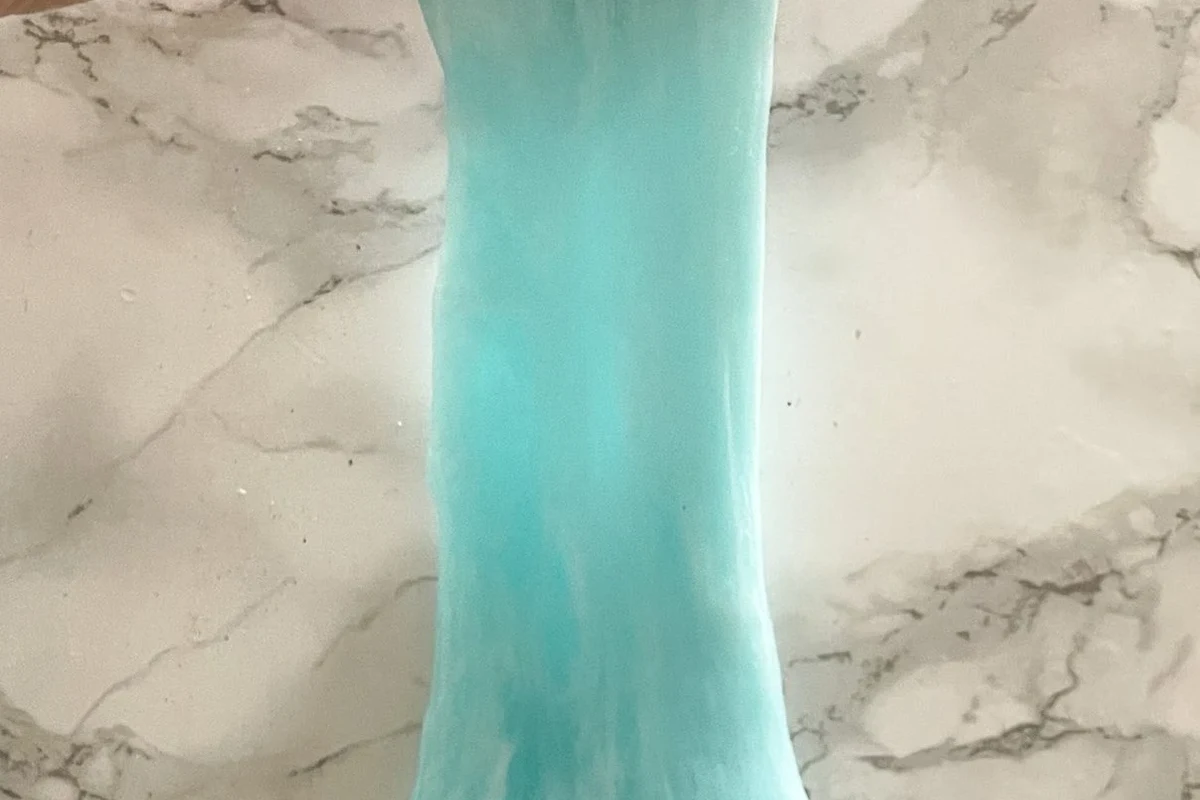 Homemade slime made with glue and baking soda in a mixing bowl