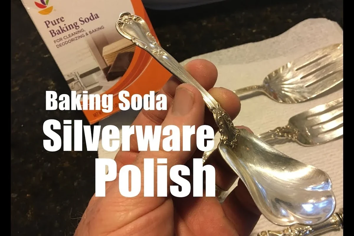 Silverware being polished with baking soda paste on a soft cloth
