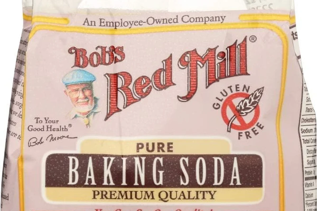 Red Mills baking soda in a baking kitchen with measuring spoons and flour