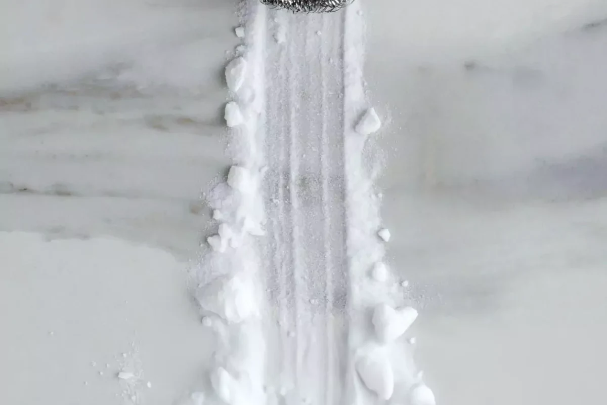 Baking soda stored in a sealed jar on a clean pantry shelf for baking freshness