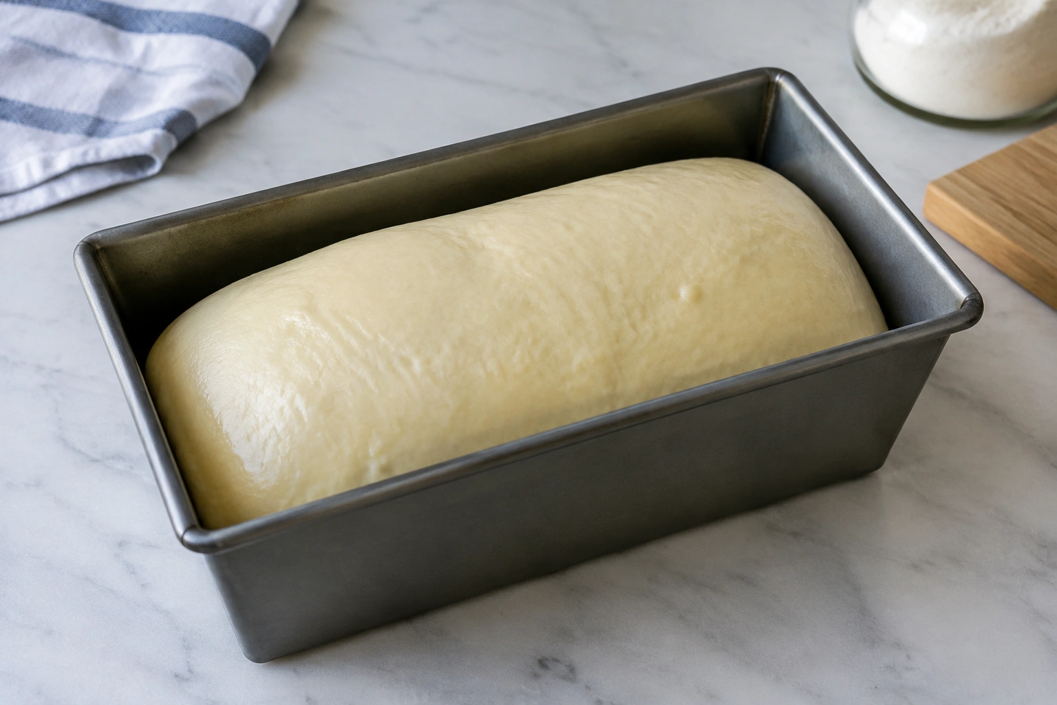 Loaf-shaped tangzhong dough in a metal pan before baking